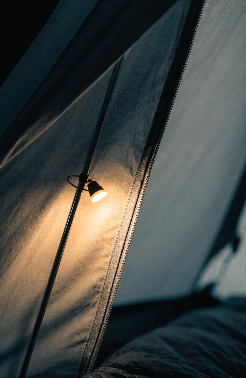 Small magnetic light attached to tent pole inside tent