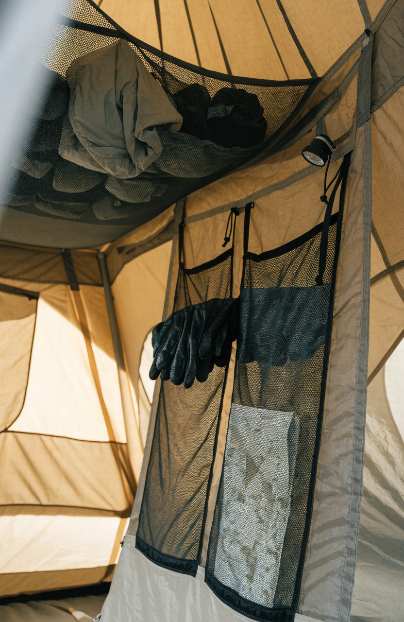 Tent wall pockets and ceiling loft holding small camping gear