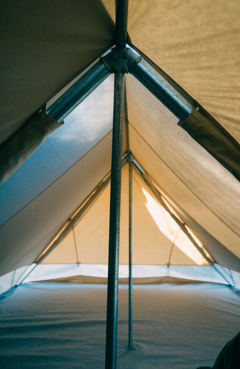 Tent interior showing ridge poles, uprights and tensioned canvas roof