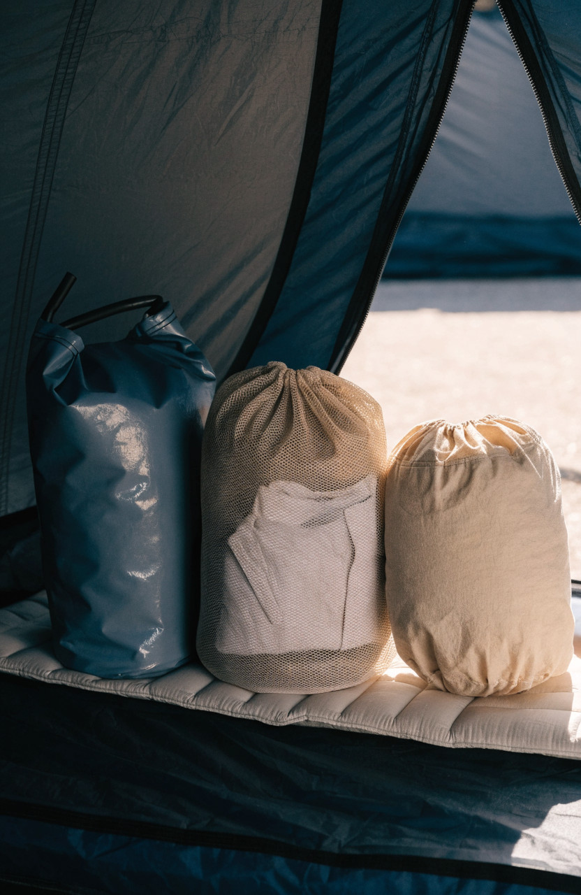 Waterproof dry bag, mesh sack and packing cube with clothes side by side